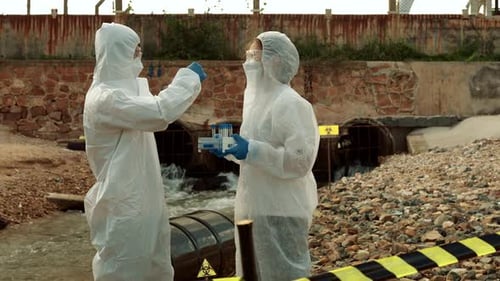 Ecologists sample water contaminated with dangerous, waterhazard toxins into tubes