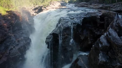A Natural Wonder: Behold the Beauty of a Waterfall Flowing through a Natural Bridge 4K