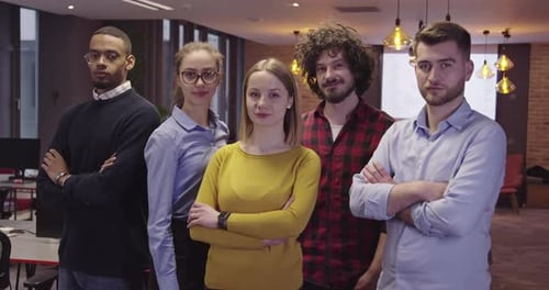 Diverse Team Posing Confidently in Modern Workplace