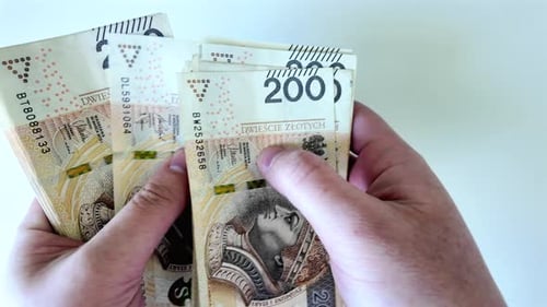 200 złotych, Counting Polish banknotes. White background.
