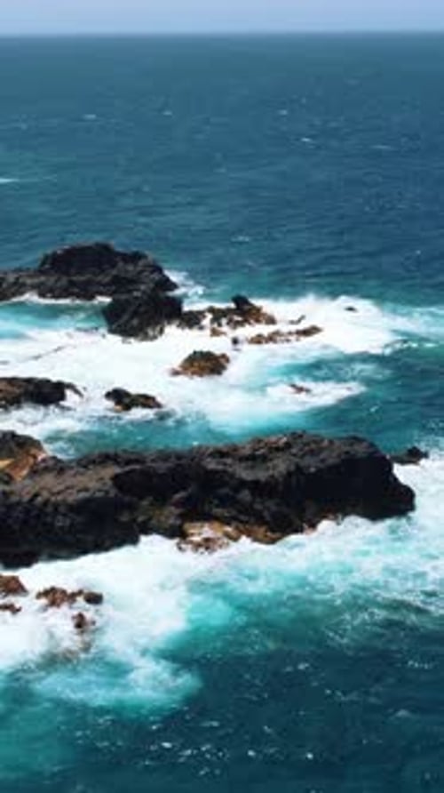 Turquoise Ocean Waves Crashing Against Rocks