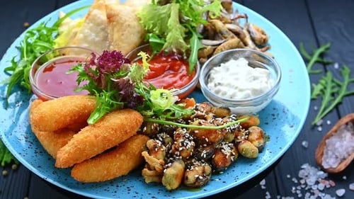 Delicious food plate with different dishes served at a restaurant.