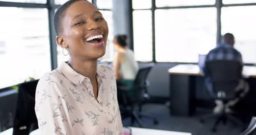 Portrait of smiling african american businesswoman in office, slow motion, copy space