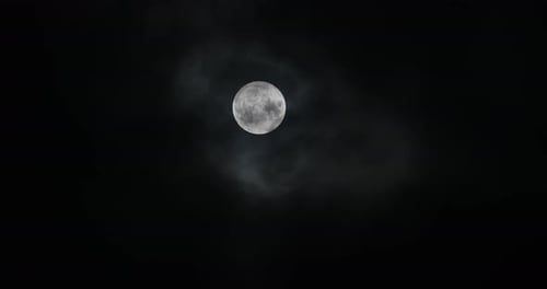 Full Moon Behind Wispy Clouds at Night