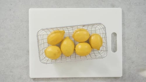 Bright Yellow Lemons on a Cutting Board