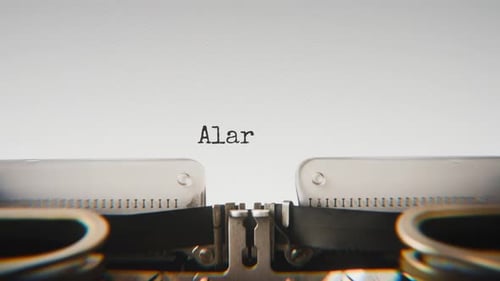 Old mechanical typewriter typing Alarm System in a close-up view.