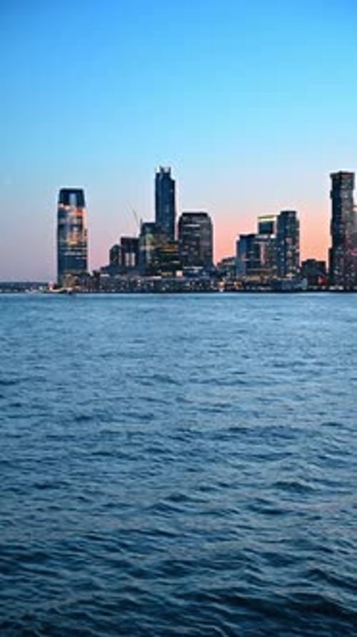 Skyline of modern New York switching on lights at sunset time.