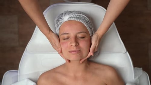 Woman Receives Soothing Facial Massage at Spa