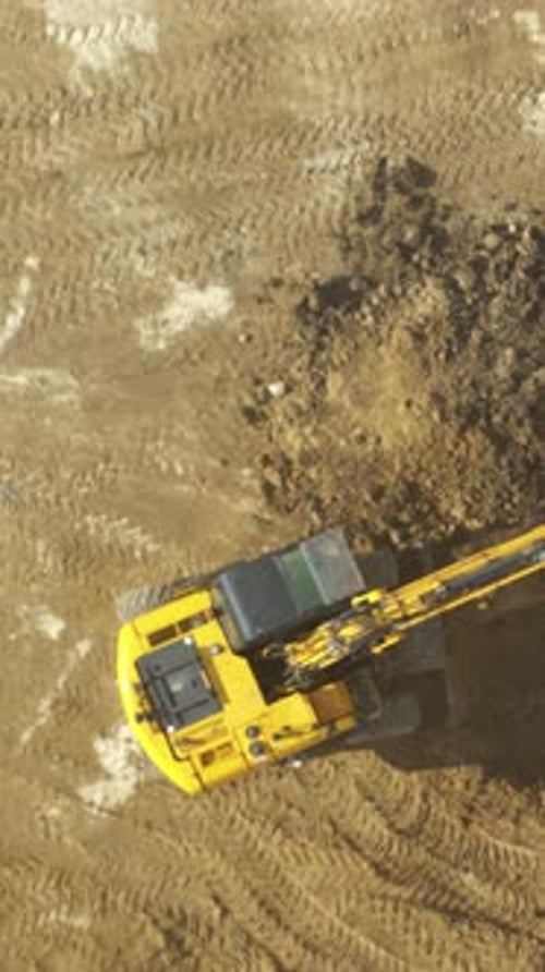 Heavy Machinery Actively Excavating Soil Surface Dramatic Shot of Digger Forming Mound on Rough