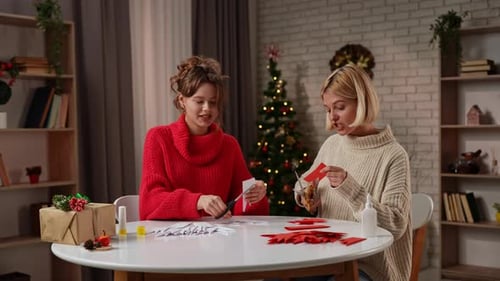 Young Women Crafting Decorations in Home for Christmas