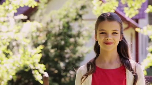 Happy smiling teenage girl enjoys summer outdoors in garden slow motion