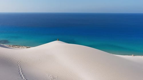 Aerial View of White Sand Dunes Meeting the Blue Ocean on Socotra Island Yemen More