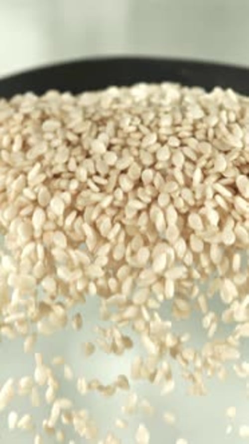 Falling Sesame Seeds From a Spoon