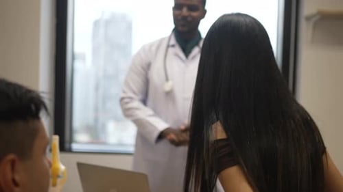 Doctor is meeting with patient at hospital.