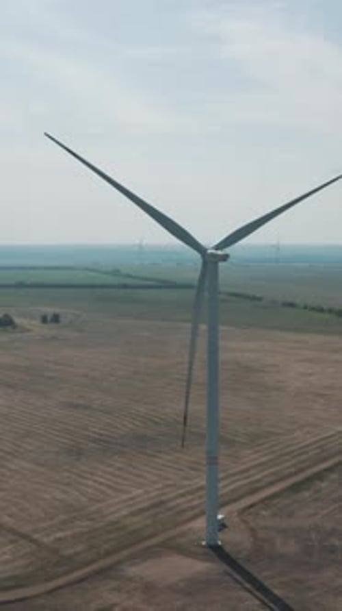 Wind Turbine Rotating in Rural Green Landscape
