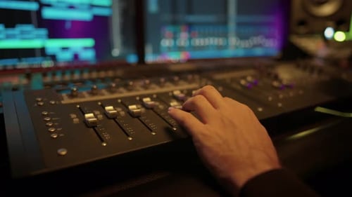 Closeup of Soundman Hand Adjusting Music Mixer in Record Studio Music Industry Recording Soundtrack