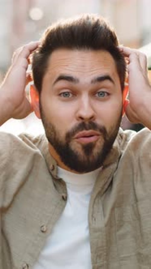 Young Man Looking Surprised at Camera Shocked By Sudden Win Good Victory News Wow in City Street