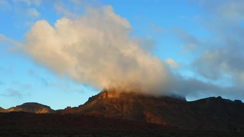 Majestic Landscape Cloudy Sunset Sky and Last Sun Rays Illuminate Hot Desert Mountain Peak in Teide