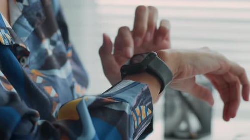 Woman's Hand Using Smartwatch at Home