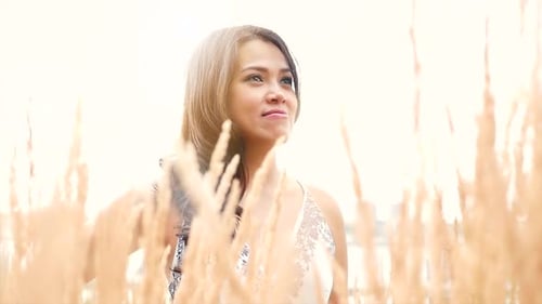 Woman Posing in Sunny Field of Golden Grass