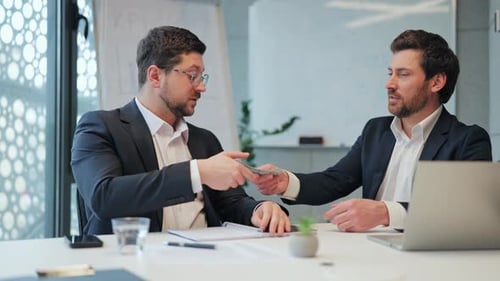 Successful Business Deal Concluded With Money Exchange and Handshake