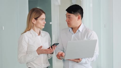 Colleagues Discussing Work in a Modern Office