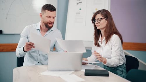 Couple of Office Workers Discussing Business
