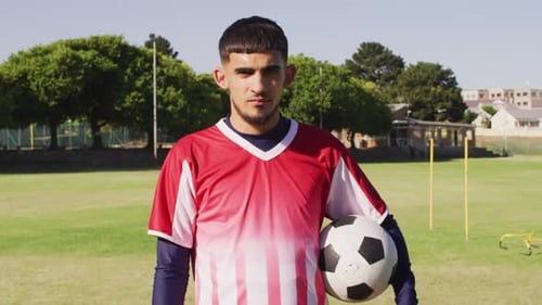 Video of biracial male football players with ball on field