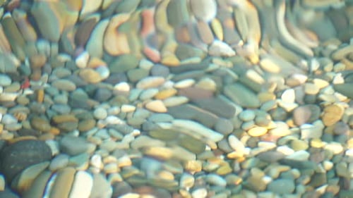 Sea Beach Pebble Sea Waves with Soft Foamy Waters Washing Multicolored Pebbles on a Beach During