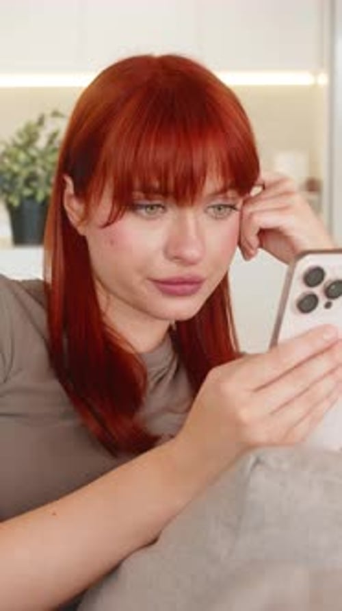Woman Relaxing At Home Using Her Mobile Phone