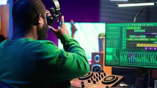 Confident Music Engineer Working on Mixing Console in Home Studio