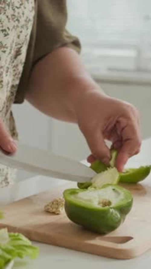 Cutting a Green Bell Pepper in Kitchen