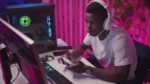 Young Adult Playing Video Game at Home