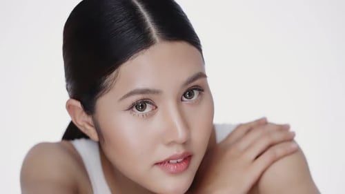 Close up beautiful female model with perfect fresh and clean skin looking at camera.