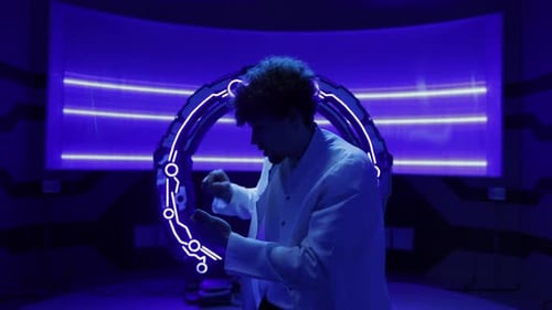 Young Adult Interacts with Holographic Technology in Futuristic Lab