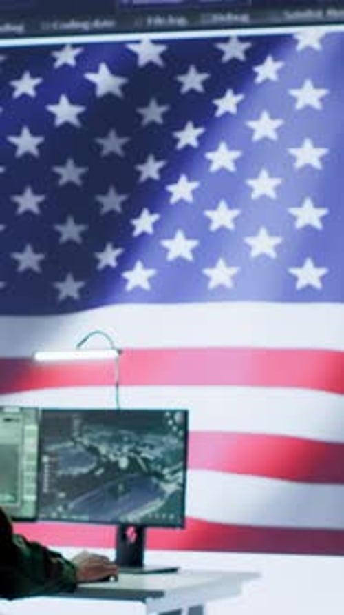 Man Saluting American Flag on Monitor