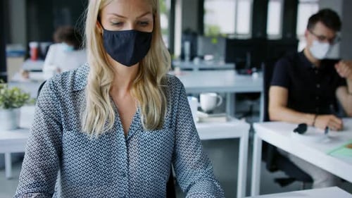 Young People with Face Masks Back at Work or School in Office