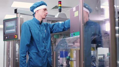 Factory Engineer Working on Manufacturing Equipment. Factory Worker Control Production Process. Male