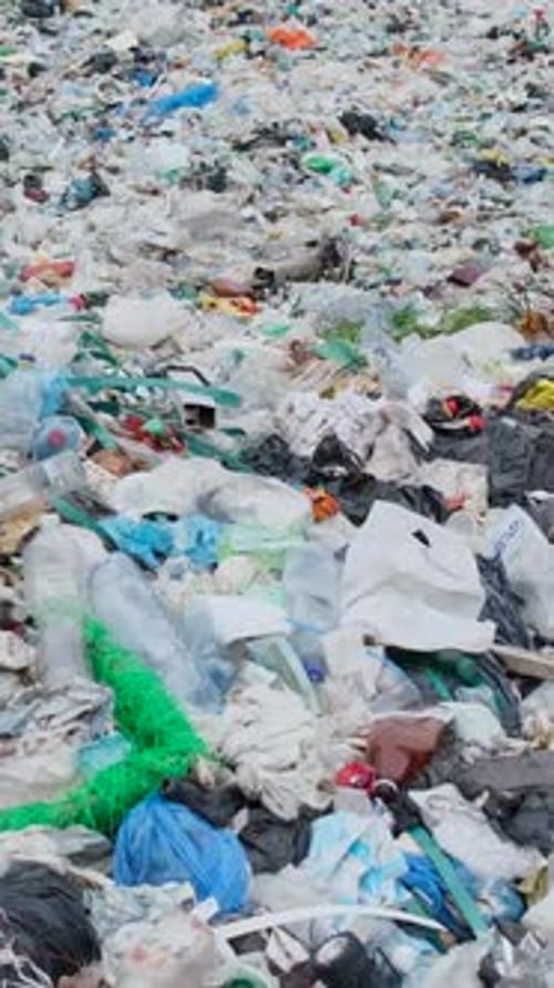Landfill overflowing with plastic bottles and trash