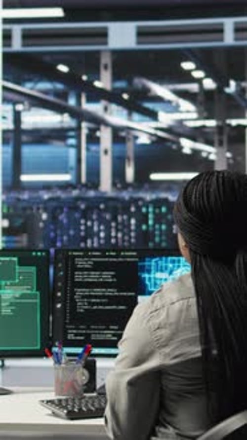 Vertical Video Server Farm IT Expert Responds to Security Breach Alert Displayed on PC Monitor