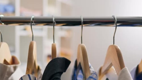Clothes Hanging in Wardrobe on Hangers