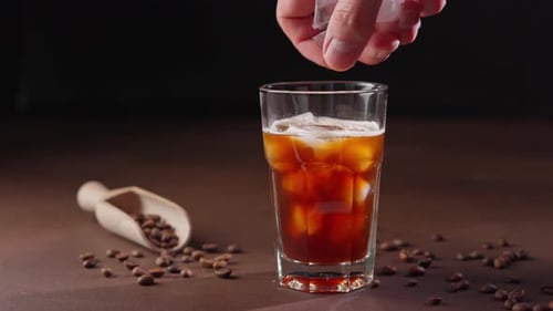 Ice Cubes Placed in Refreshing Cold Coffee Drink