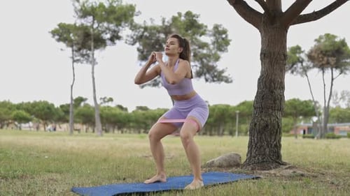 A Woman is Doing a Workout in a Park