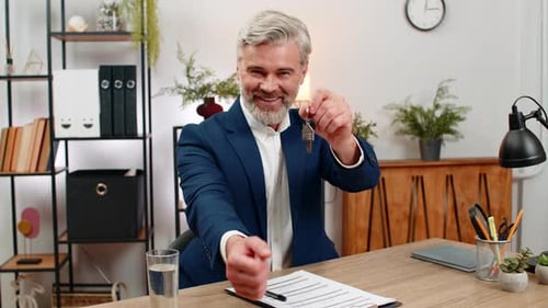 Middleaged Businessman Signs Lease Holds Apartment Keys Smiles Shakes Agent Hand Marking Milestone