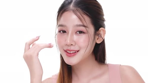 Close up portrait beautiful young Asian woman with healthy facial skin over white background.