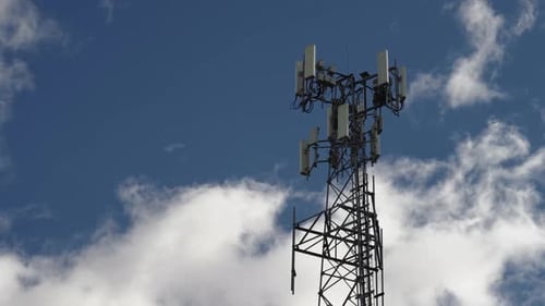 Timelapse of a cell tower with a fast-moving sky in the background.
