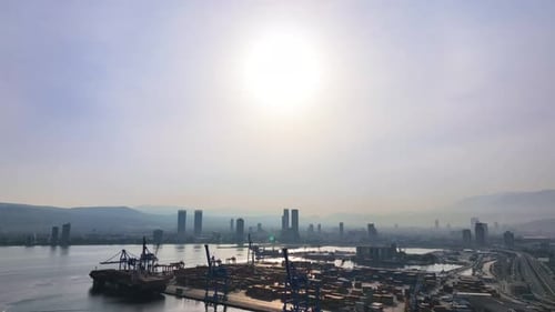 Aerial View of Urban Port with Ships and Cranes