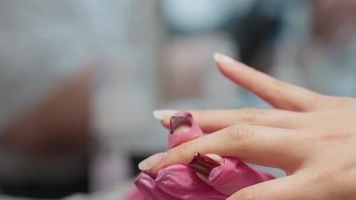 Close-Up: Nail Technician Applying Gel on Woman's Hand