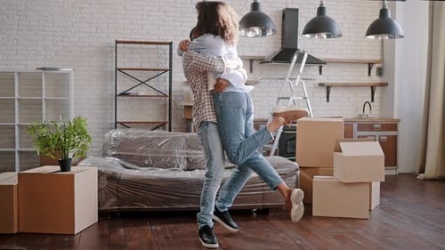 Slow Motion of Young Ethnic Couple Moving Into New Home Hugging Together and Turning Around Excited