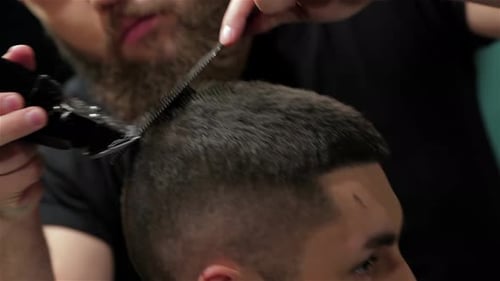 Men's Hairstyling and Haircutting with Hair Clipper in a Barber Shop or Hair Salon